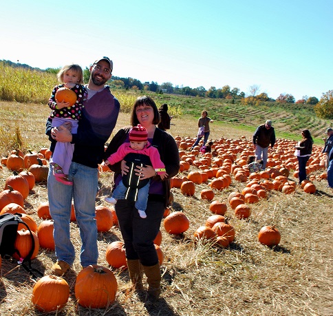 This picture was taken last year. It was our first pumpkin picking trip with both of our girls! 
